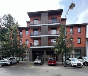 a building with cars parked in front of it at CENTRIKA city center apartment Self Check-in in Klaipėda
