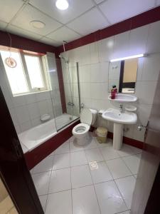 a bathroom with a toilet and a sink and a shower at Room for rent daily and monthly in Ajman 