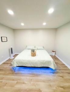 a bedroom with a bed with a blue lighted floor at Emperors Pool House in Jacksonville