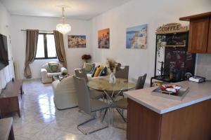 a kitchen and living room with a table and chairs at Aegean Escape in Nea Makri