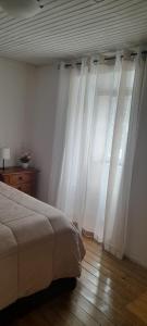 a bedroom with white curtains and a bed at Casa do Freire - Serra da Estrela in Aguincho +16 photos