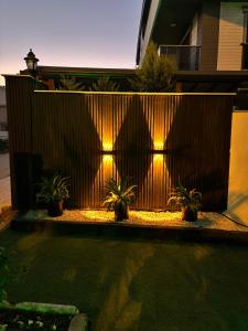 a fence with potted plants in front of a house at akdenız suıtes in Altınkum +9 photos