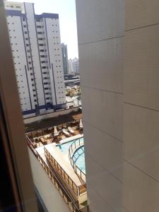 a view of a pool from a balcony of a building at Imprensa III · Comfort and family in Brasilia in Brasilia