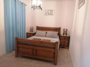 a bedroom with a bed and two night stands at Casa da Tia Bia in Venda