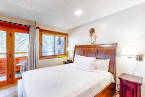 a bedroom with a large bed with a wooden headboard at Unit 18A at Granlibakken in Tahoe City +18 photos