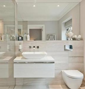 a white bathroom with a sink and a toilet at Gran View Apartment Sea Wiew, WiFi,Garage, Car rental in Adeje