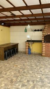 a room with tables and chairs in a building at Itaipuaçu Central in Maricá +10 photos