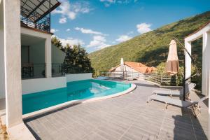 a villa with a swimming pool and a mountain at Dolce Luxury Villa in Nižepole