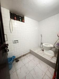 a dirty bathroom with a toilet in a room at Babu vishwanath singh Paying Guesthouse in Varanasi
