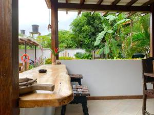 a kitchen with a wooden sink on a balcony at CasaBella Cabaña con Piscina Palomino in Palomino