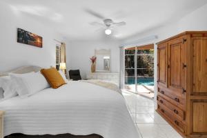 a bedroom with a bed and a sliding glass door at Private Pool Home with Backyard Oasis & Family-Friendly Comfort in Cape Coral FL in Cape Coral +43 photos