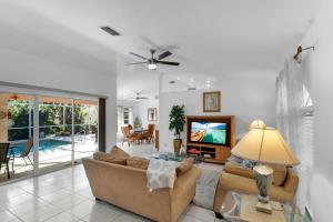 a living room with a couch and a television at Private Pool Home with Backyard Oasis & Family-Friendly Comfort in Cape Coral FL in Cape Coral