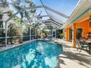 an indoor swimming pool with a pergola at Private Pool Home with Backyard Oasis & Family-Friendly Comfort in Cape Coral FL in Cape Coral