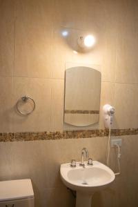 a bathroom with a sink and a mirror at Hotel del Monumento in Salta