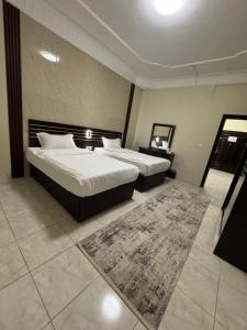 Giường trong phòng chung tại فـالـي ريزيدنـس - Valley Residence +79 ảnh
