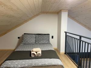 a bedroom with a bed with two shoes on it at LoveLas - Apartamenty in Smerek