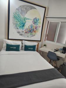a bedroom with a bed and a picture of a bird at HERMILA Tlalpan in Mexico City +7 photos