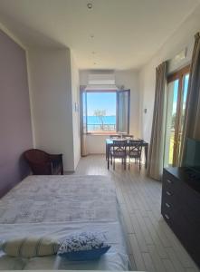 a bedroom with a bed and a view of the ocean at Cala Dei Mori in Livorno