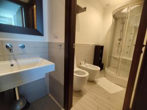 a bathroom with a sink and a toilet and a shower at Cala Dei Mori in Livorno