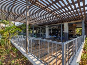 an outdoor deck with a wooden pergola at Ballito Hills - Ocean View, Queen Bed & Free Wi-Fi in Durban