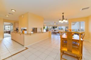 a kitchen and living room with a table and chairs at Kona Vistas by SkyRun Kona Coast in Kailua-Kona