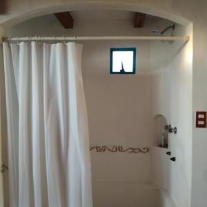 a white shower curtain in a bathroom with a window at Habitación doble con baño y vista a la montaña in San Pablo Etla +61 photos