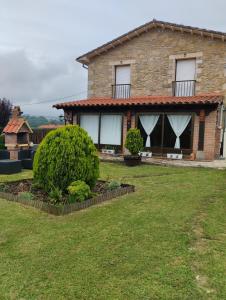 a large stone house with a grass yard at Hospedaje Vega in Santillana del Mar +93 photos