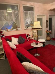 a red couch with teddy bears on it in a living room at Novi in Grünstadt