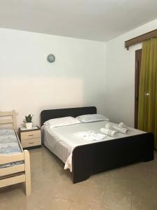 a bedroom with a bed with two towels on it at Dario's Apartaments 2 in Orikum