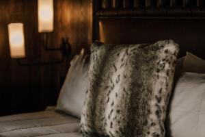 a pillow sitting on top of a bed with two pillows at Caryonah Hunting Lodge in Crossville