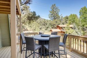 a patio with a table and chairs on a deck at Walk to Village Cozy Cabin in Pine Mountain Club! in Pine Mountain Club