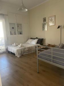 a bedroom with two beds and a table in it at Casa di Irene in Agios Rokkos