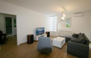 a living room with a couch and a tv at Ada Lake new apartment in Belgrade