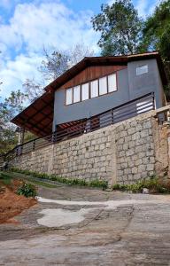 a house on top of a stone wall at Chalé do Mato in Itatiaia