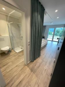 a bathroom with a shower and a toilet and a sink at Stunning Wörthersee Holiday Home 16 in Sekull
