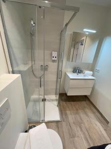 a bathroom with a shower and a sink at Stunning Wörthersee Holiday Home 16 in Sekull +55 photos
