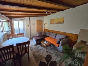 a living room with a couch and a table at Apartments PHARIA in Jelsa