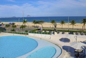 a swimming pool with a beach in the background at Hotel Nacional Rio de Janeiro in Rio de Janeiro