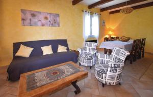 a living room with a bed and chairs and a table at Le Petit Nice in Chamaret
