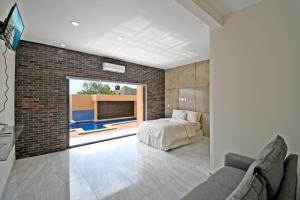a bedroom with a bed and a brick wall at STELLA MARIS Boutique Hotel in El Sargento