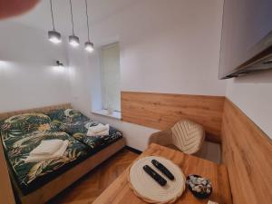 a small room with a bed and a table at JEDLINA Park in Jedlina-Zdrój