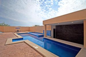 a swimming pool in a house with a patio at STELLA MARIS Boutique Hotel in El Sargento