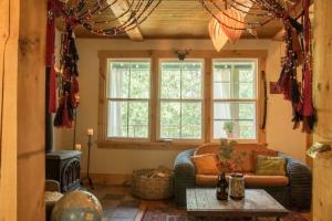 a living room with a couch and a table at Spa & Water access - Pionnier in Mont-Tremblant