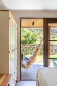 Ένα ή περισσότερα κρεβάτια σε δωμάτιο στο Diamantino Residence - Garden - Sertão