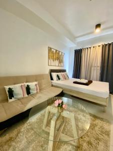a living room with a couch and a table at Tagaytay Staycation by SMDC WIND RESIDENCES LAKEVIEW in Kaybagal +11 photos