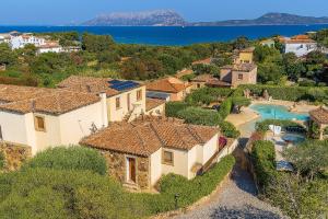 an aerial view of a house with a swimming pool at Wind Rose Exclusive -Natural pool 50 m from the Sea in Olbia