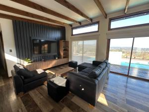 a living room with a couch and a tv at Chalet Exclusive CasaBlanca in Casablanca