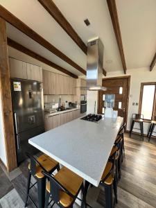 a kitchen with a large white island in a kitchen with chairs at Chalet Exclusive CasaBlanca in Casablanca