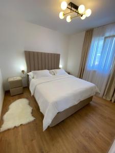 a bedroom with a large bed with a white bedspread at Vila Sunset in Kaštela +42 photos