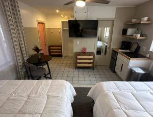 a bedroom with a bed and a kitchen with a table at Arvilla Resort in St Pete Beach